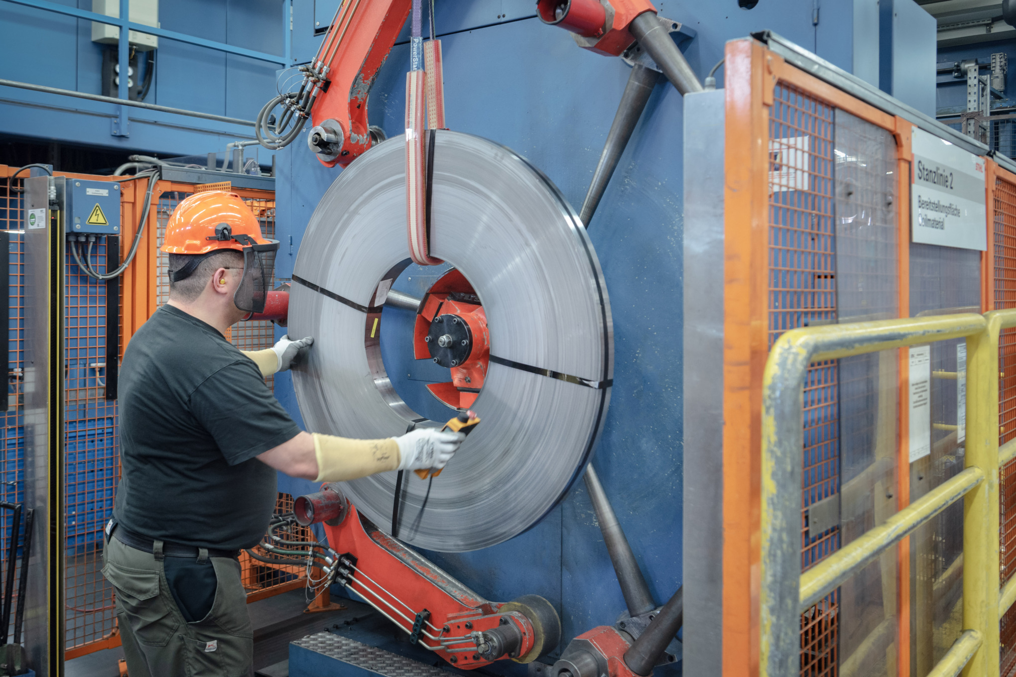 Ein Mann in Schutzausrüstung arbeitet an einer Maschine zur Schienenherstellung bei STIHL 